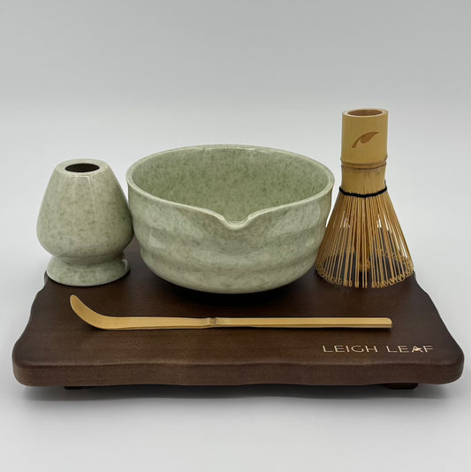Elevate your tea-making ritual with this 5 Piece Matcha Whisk Set with Wooden Display Board by Leigh Leaf, featuring a green matcha bowl, bamboo whisk, and stylish wooden display for organized elegance.